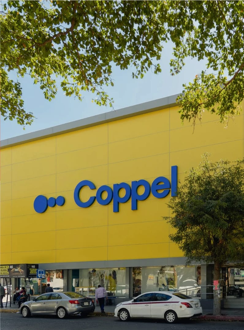 A Coppel department store: blue Coppel lettering on a yellow façade above the street entrance