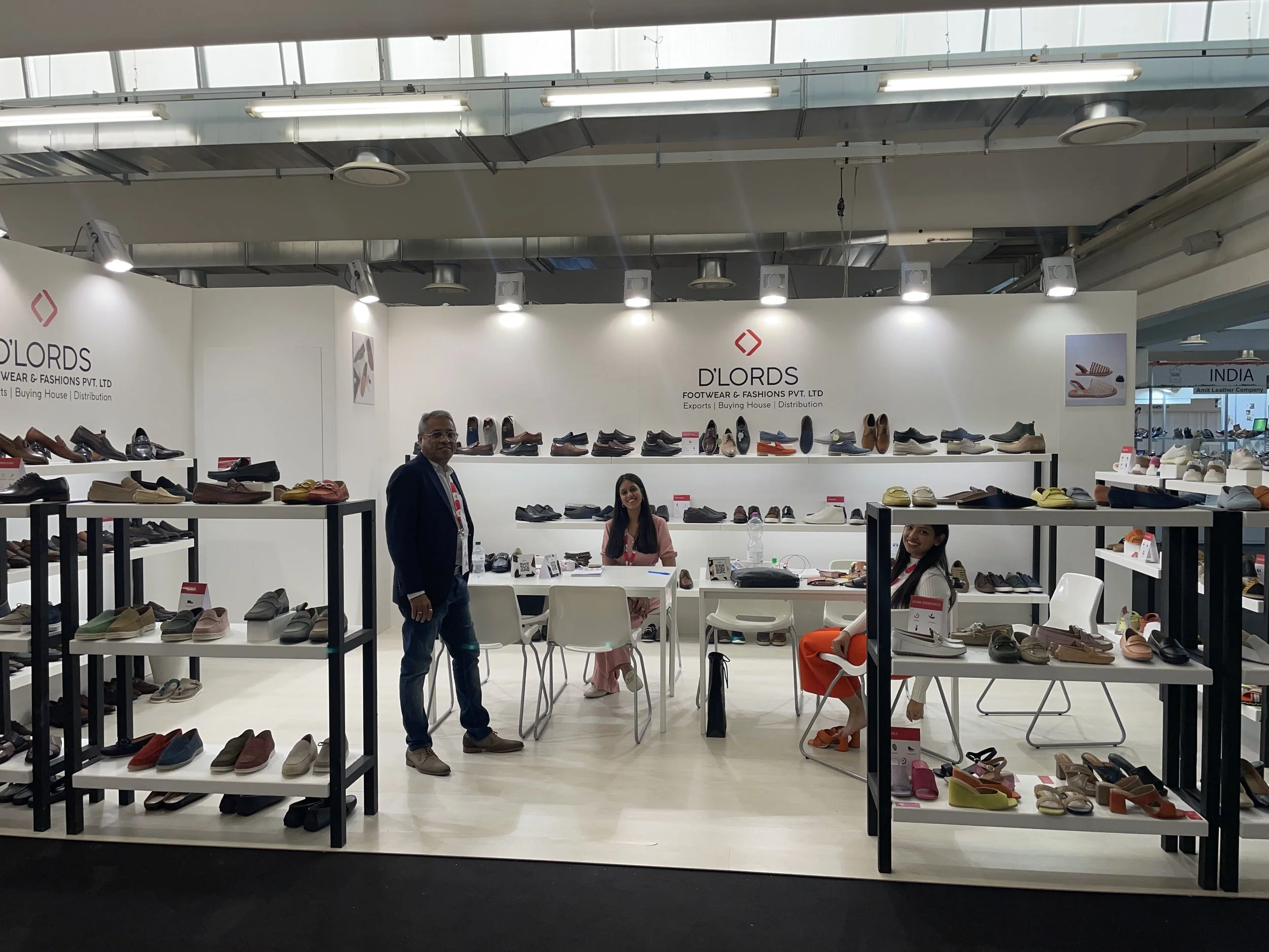 The Dlords stand at a footwear trade show, staffed by the team