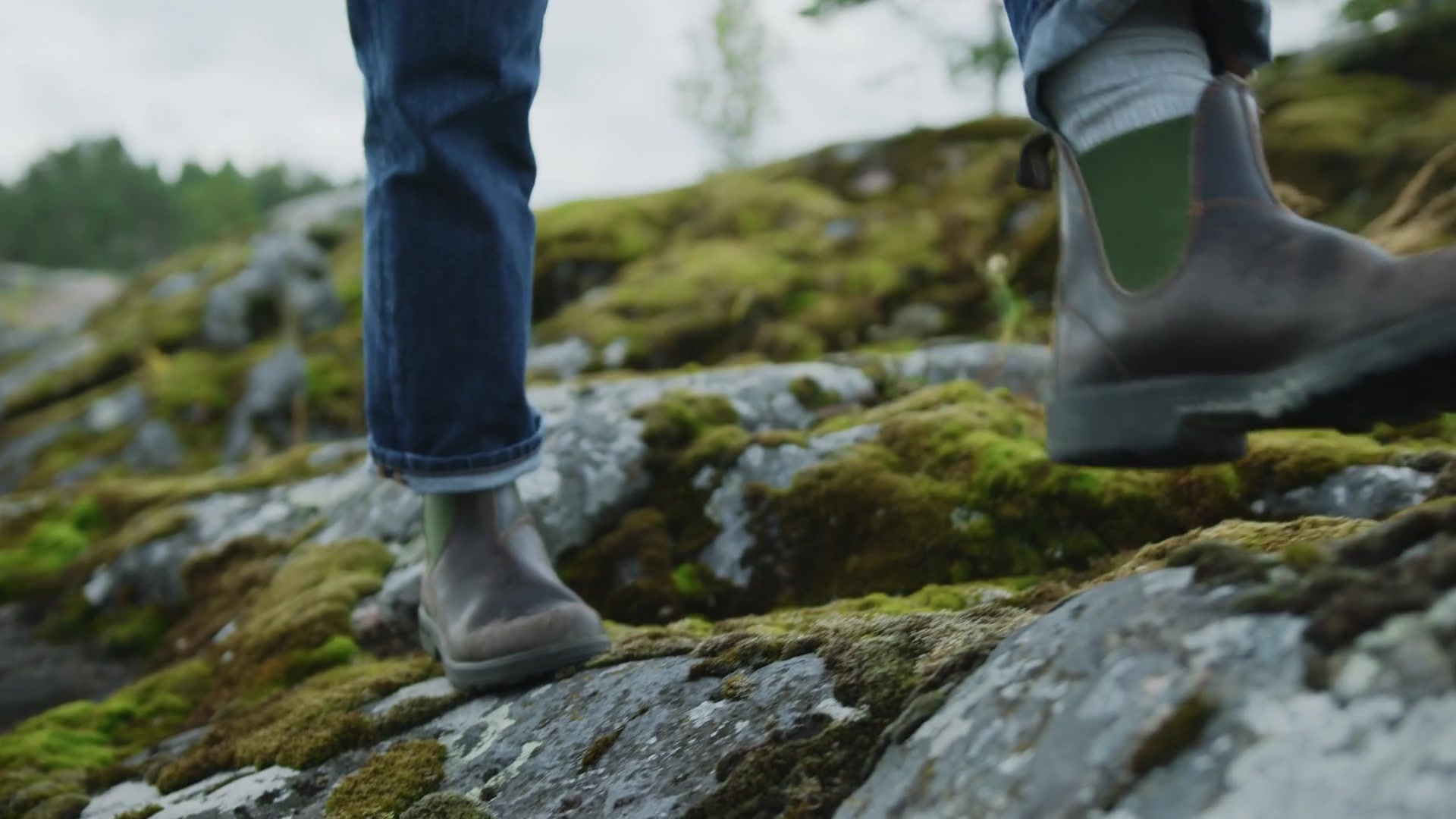 Leather Chelsea boots worn on a mossy rock trail